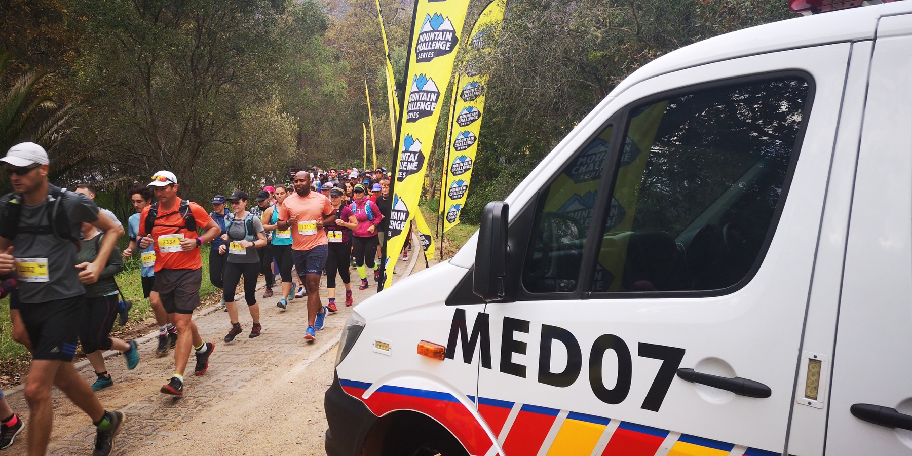 Runners passing a Cape Medics ambulance at the Mountain Challenge Series