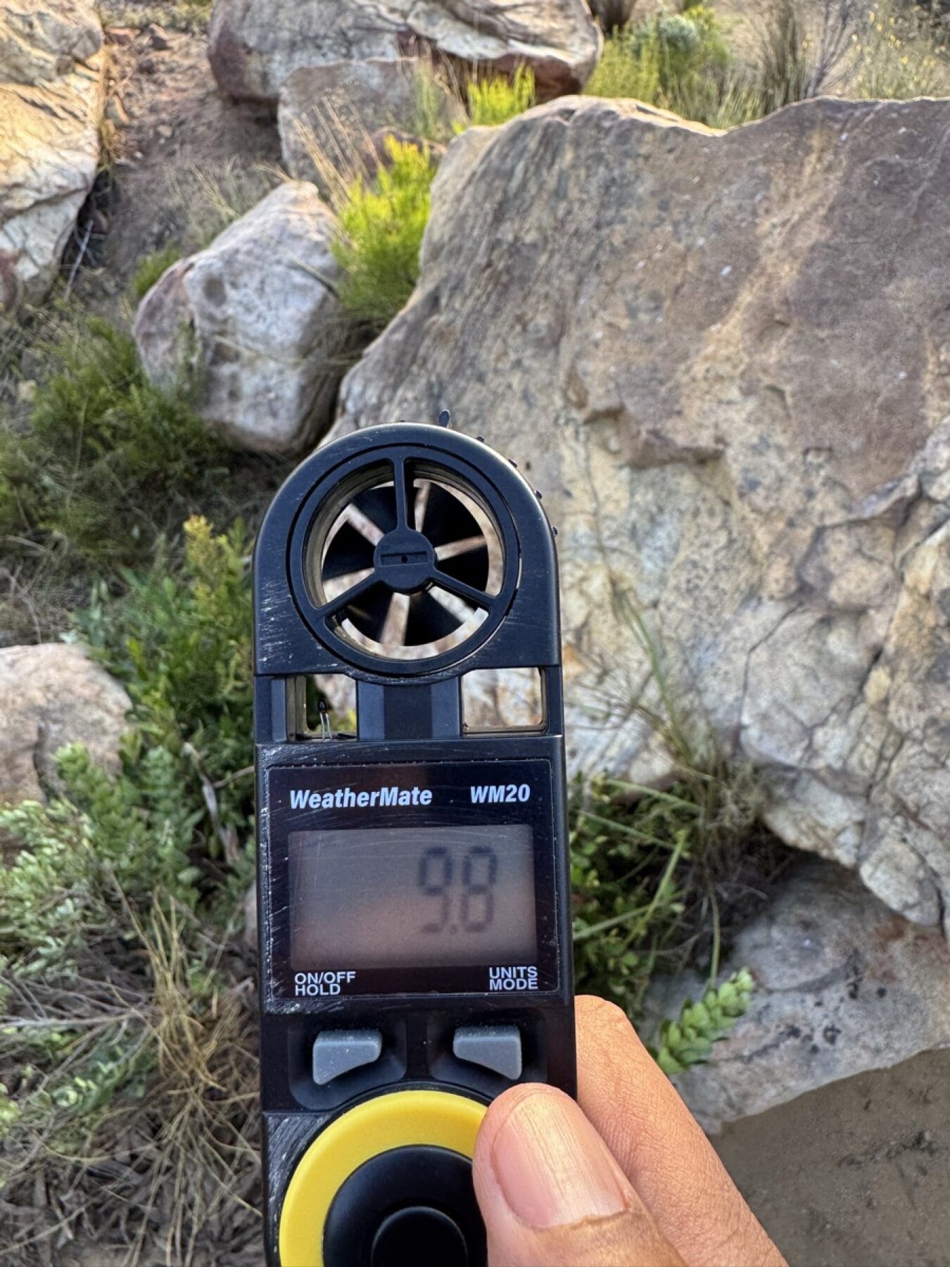 Handheld wind meter in use outdoors on location